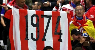 Atlético Madrid players pose with World Cup trophy at stadium